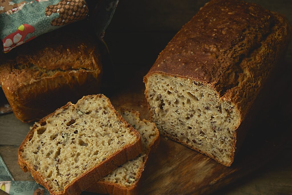 Sliced homemade gluten-free vegan bread on a wooden board